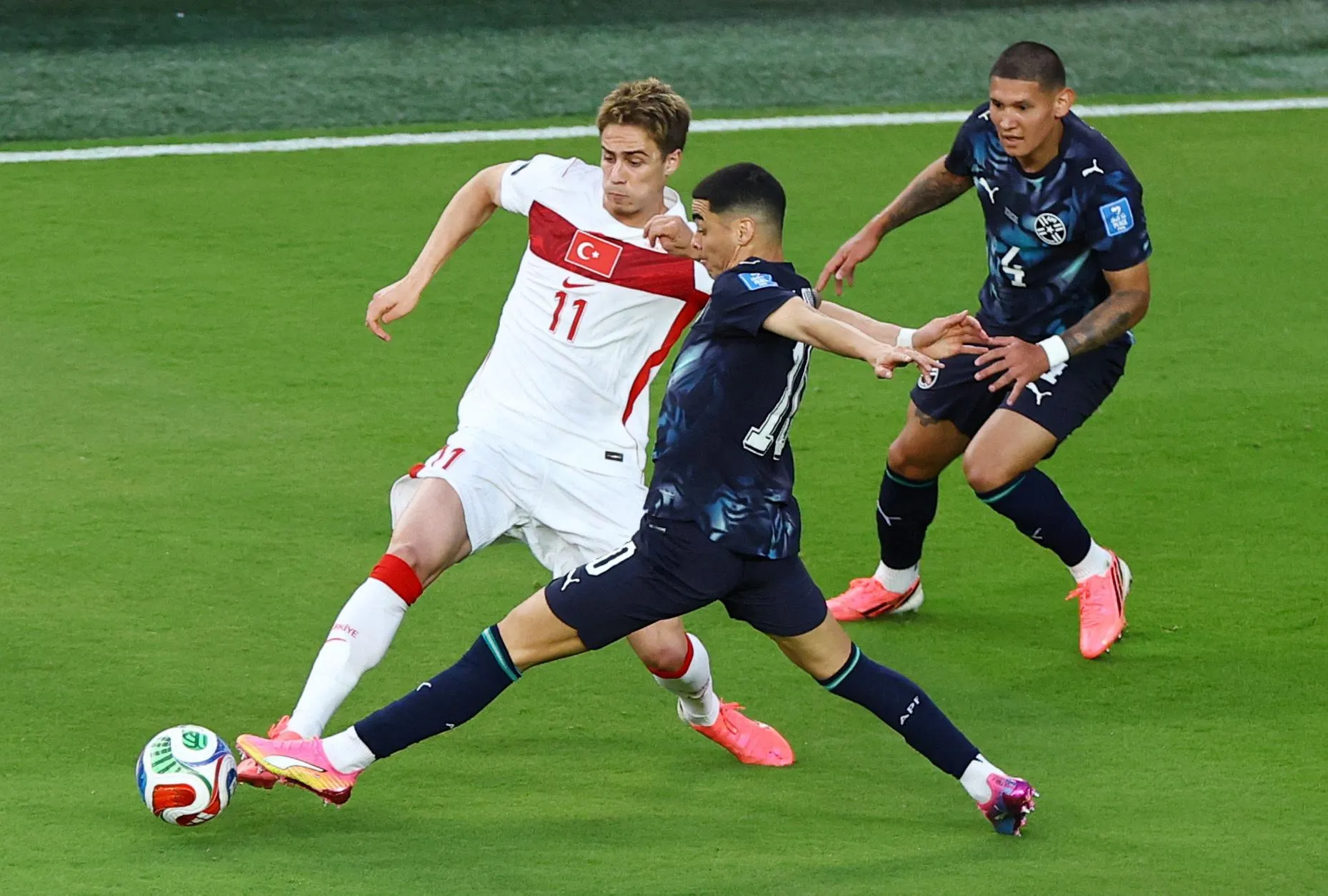 Paraguay's Miguel Almiron in action with Turkey's Kenan Yildiz.