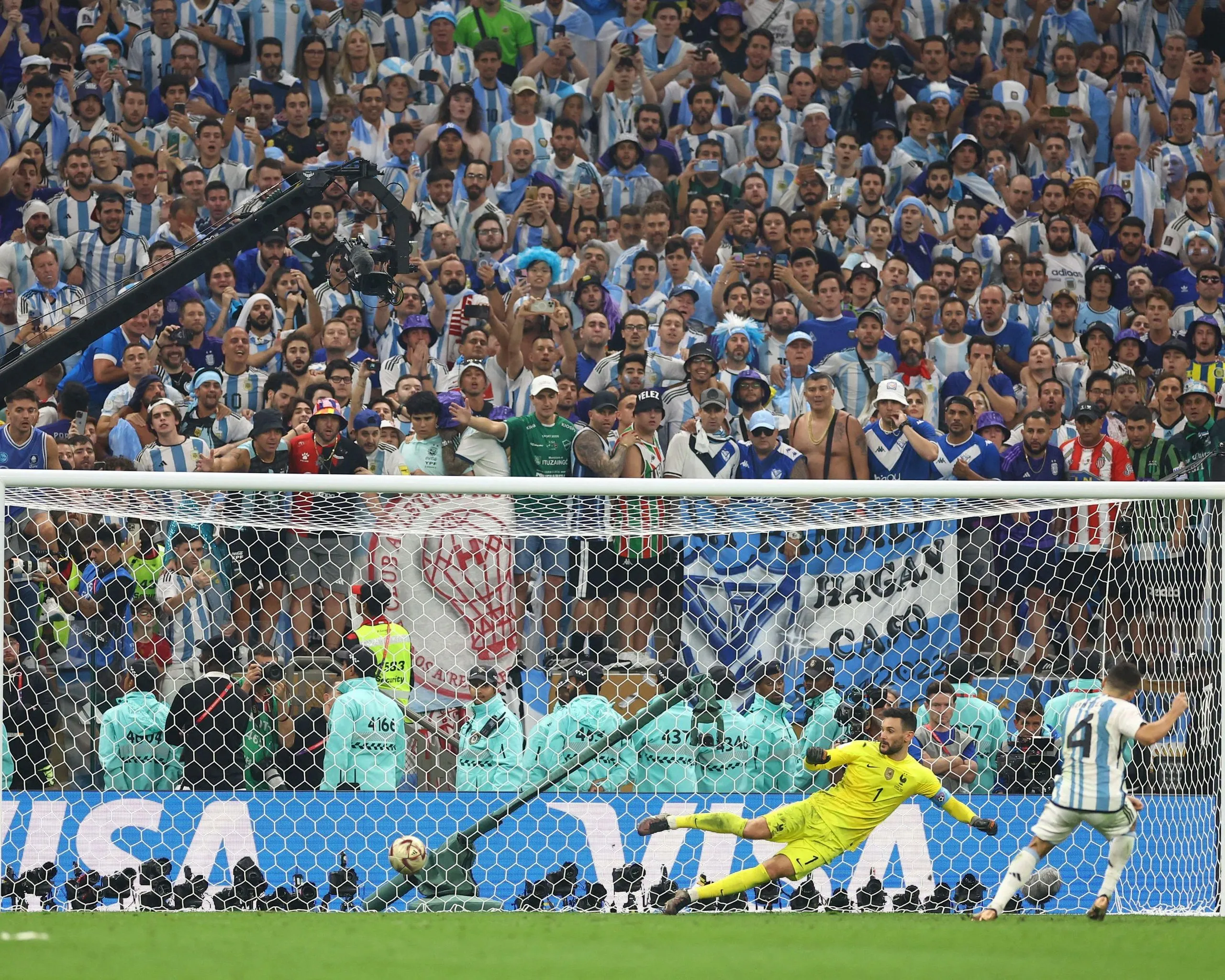 The Argentina footballer Gonzalo Montiel (wearing No 4) scores a penalty past the France goalkeeper Hugo Lloris (wearing No 1) to win Argentina the 2022 World Cup.