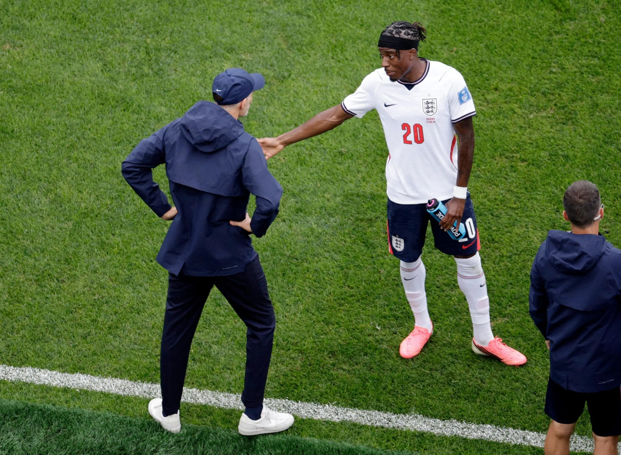 England manager Thomas Tuchel gives instructions to Noni Madueke during a break in play
