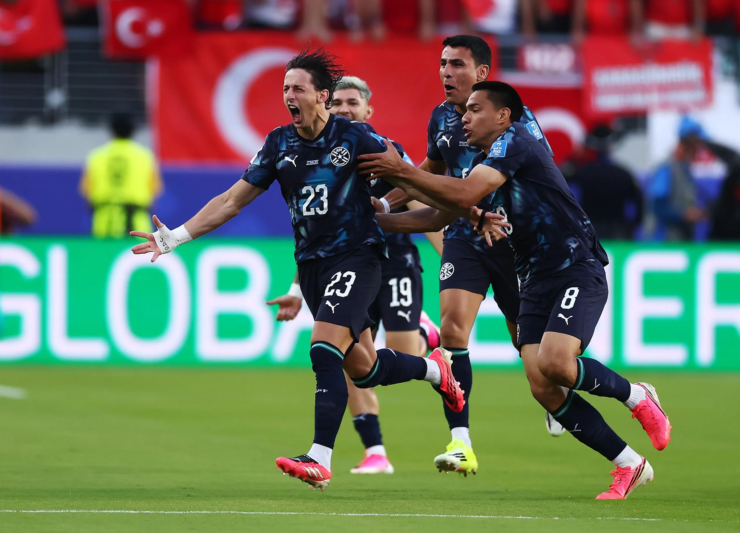 Matias Galarza (23) of Paraguay celebrates with teammates after scoring the team's first goal!