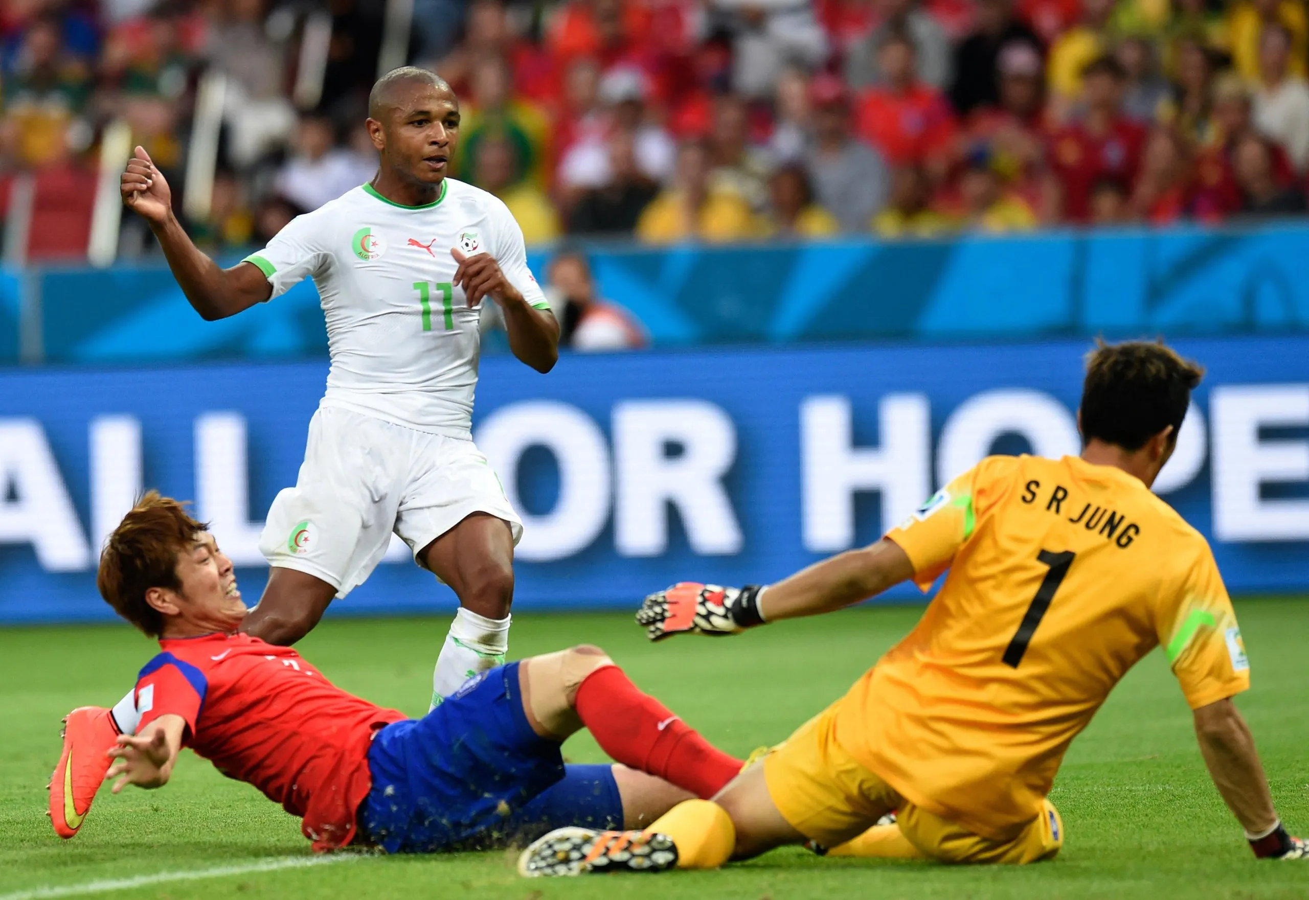 Yacine Brahimi of Algeria evades a tackle from the South Korea defender Yun Suk-young and scores past the goalkeeper Jung Sung-ryong during their 2014 World Cup group game in Porto Alegre.