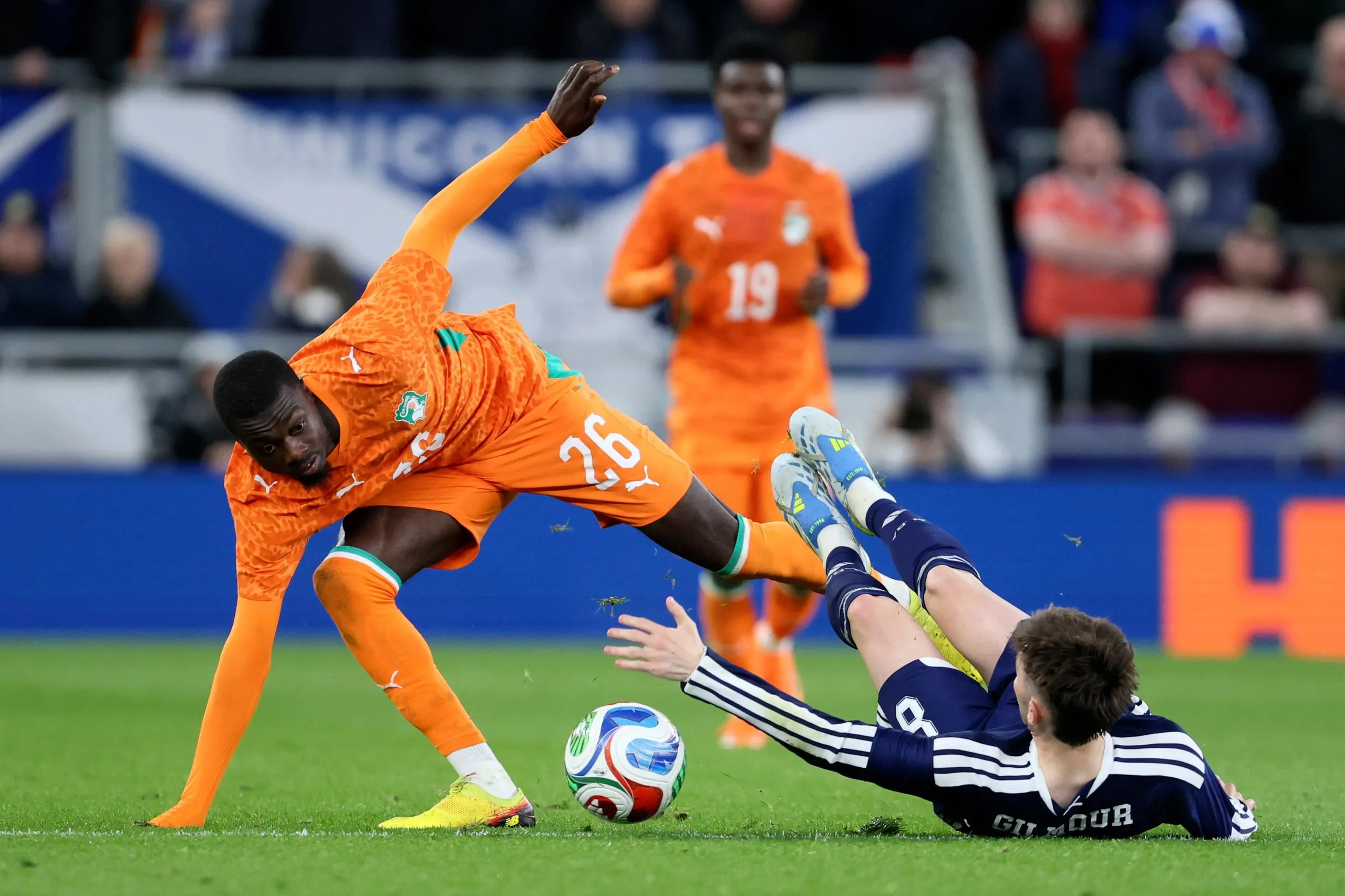 Nicolas Pépé of Côte d’Ivoire and Billy Gilmour of Scotland challenge for the ball.