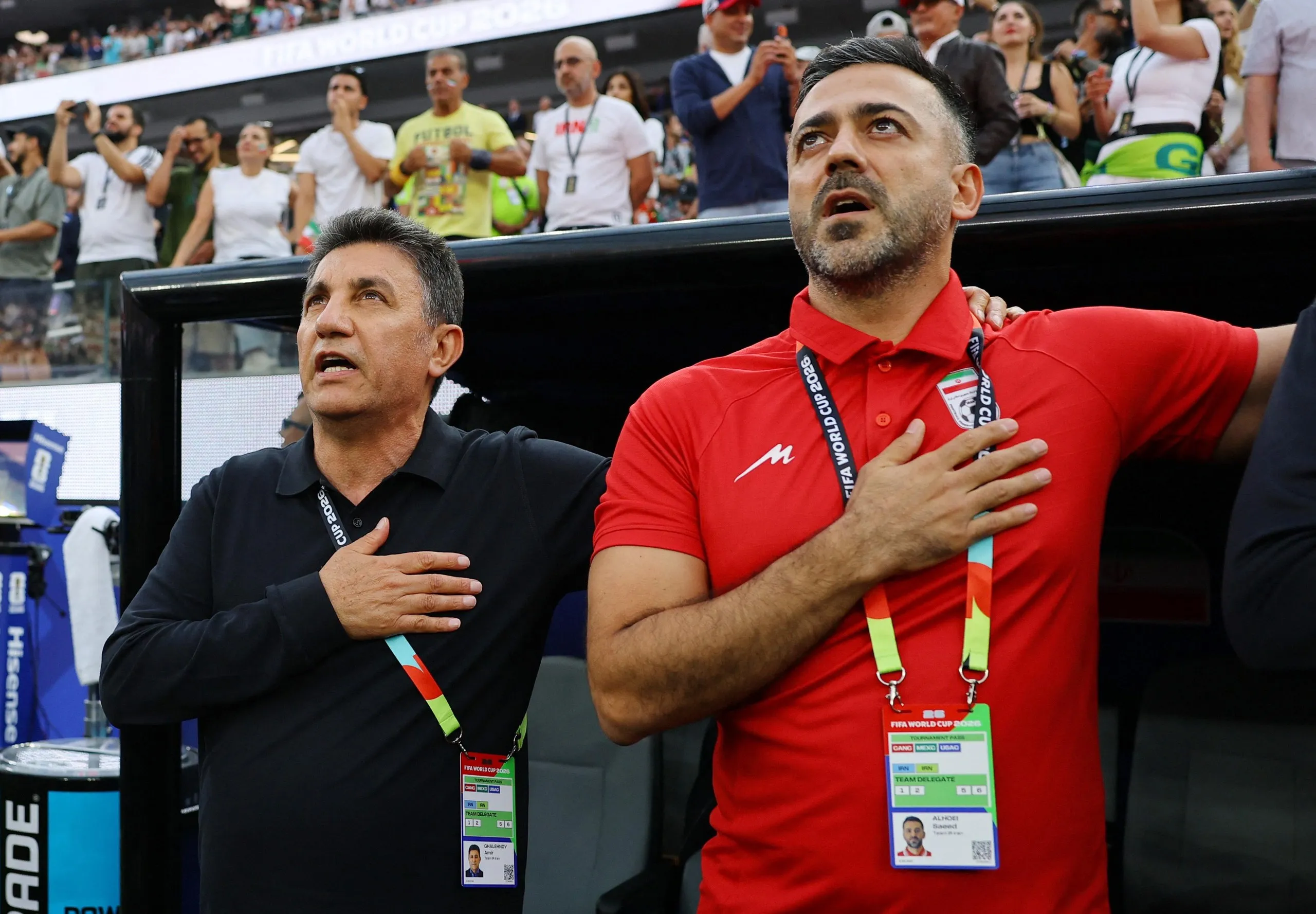 Iran coach Amir Ghalenoei and assistant coach Saeed Alhoei during the national anthems before the match against Egypt