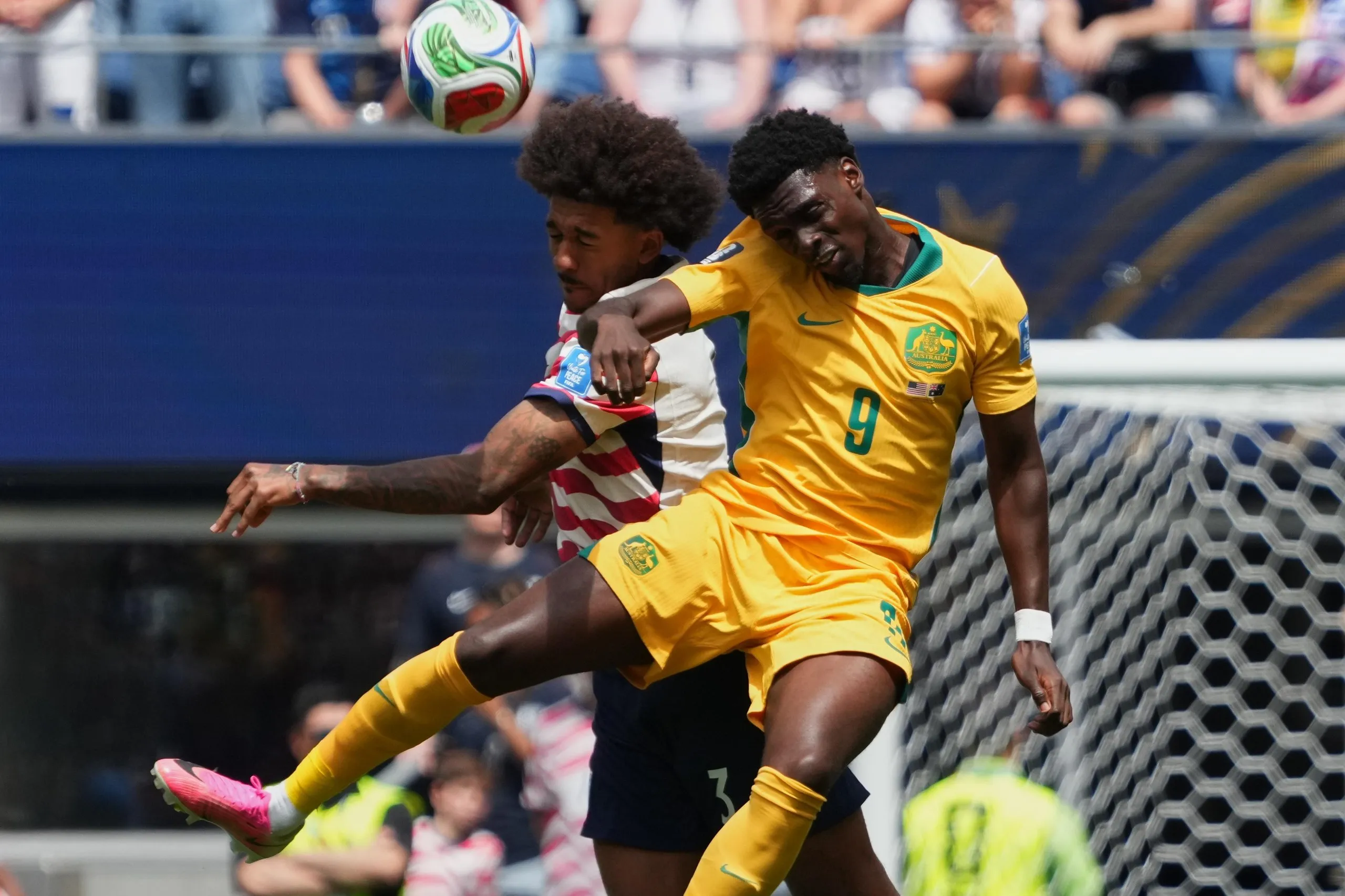 Chris Richards and Australia’s Mohamed Toure conteat a header.