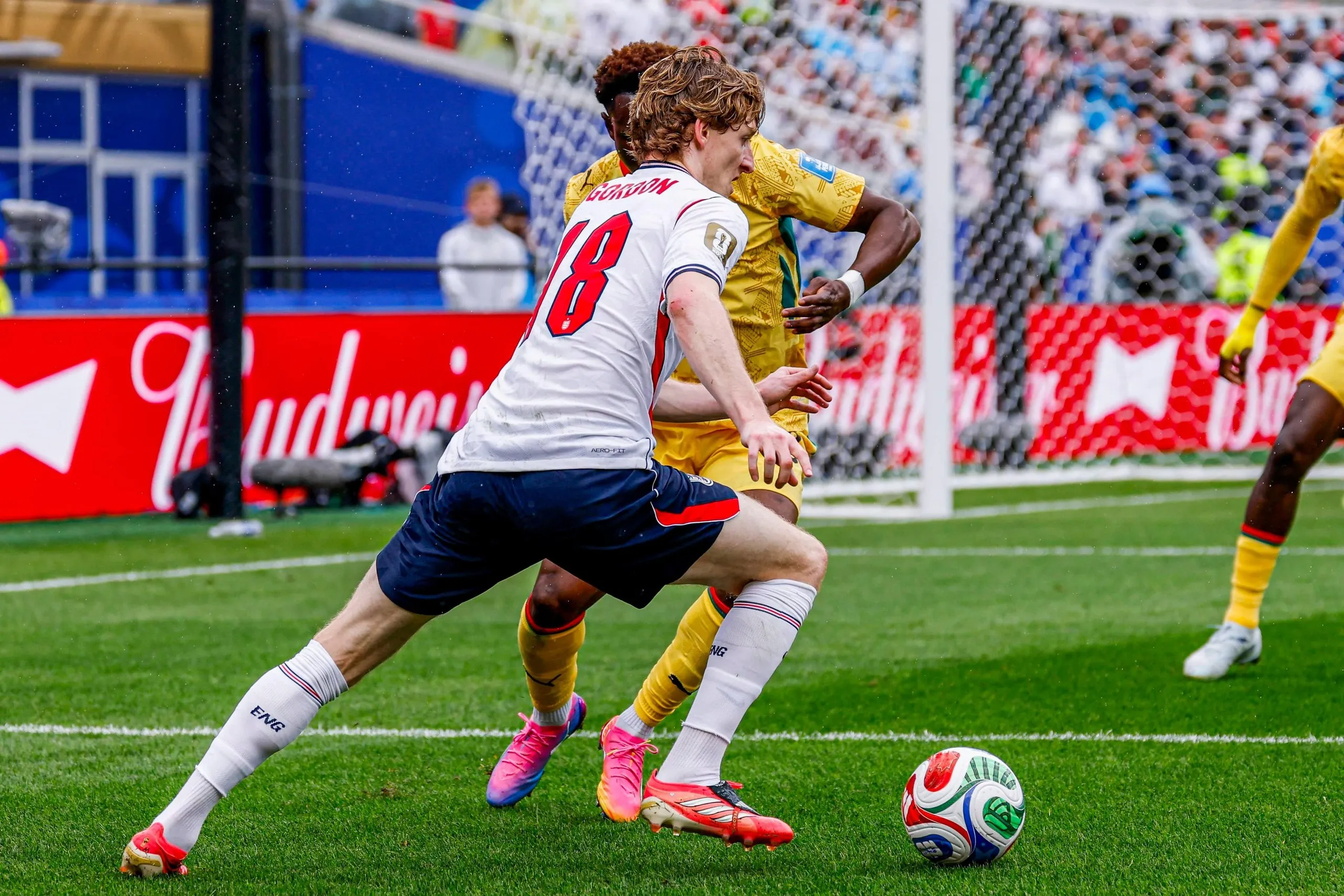 Anthony Gordon of England dribbles with the ball under pressure from Marvin Senaya of Ghana during the World Cup 2026 Group L match
