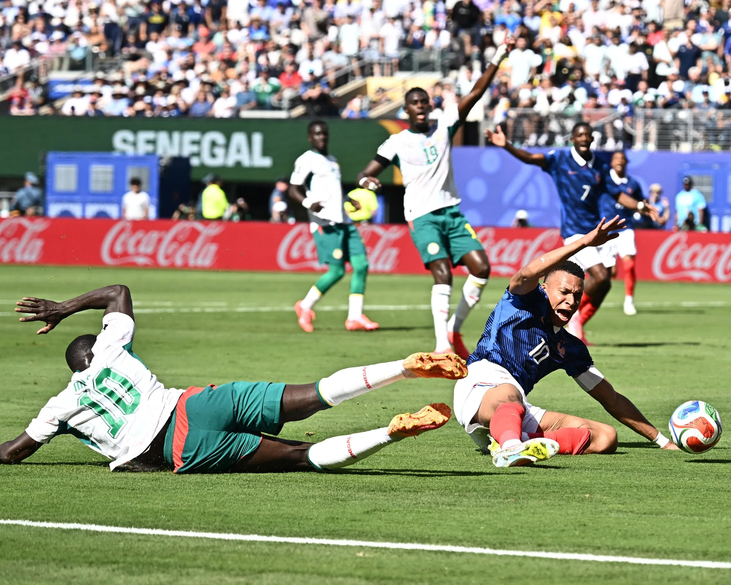 Senegal's Sadio Mane challenges France's Kylian Mbappe in the penalty area leading to a VAR review.