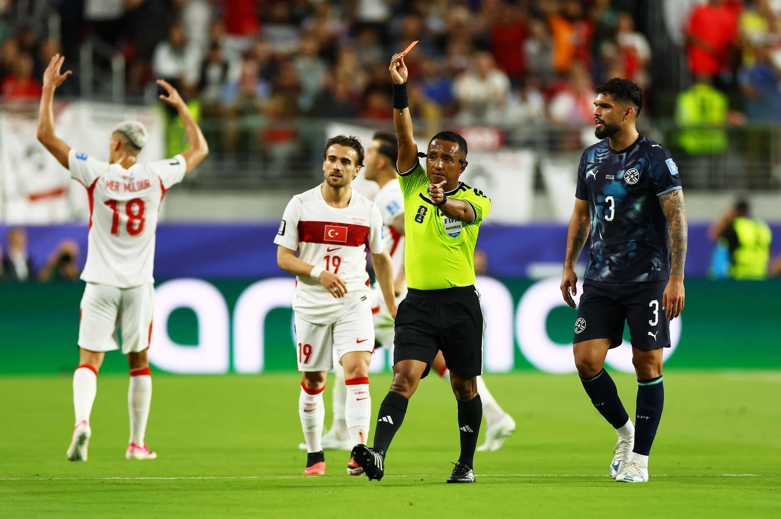 Referee Ivan Barton shows a red card to Paraguay's Miguel Almiron.