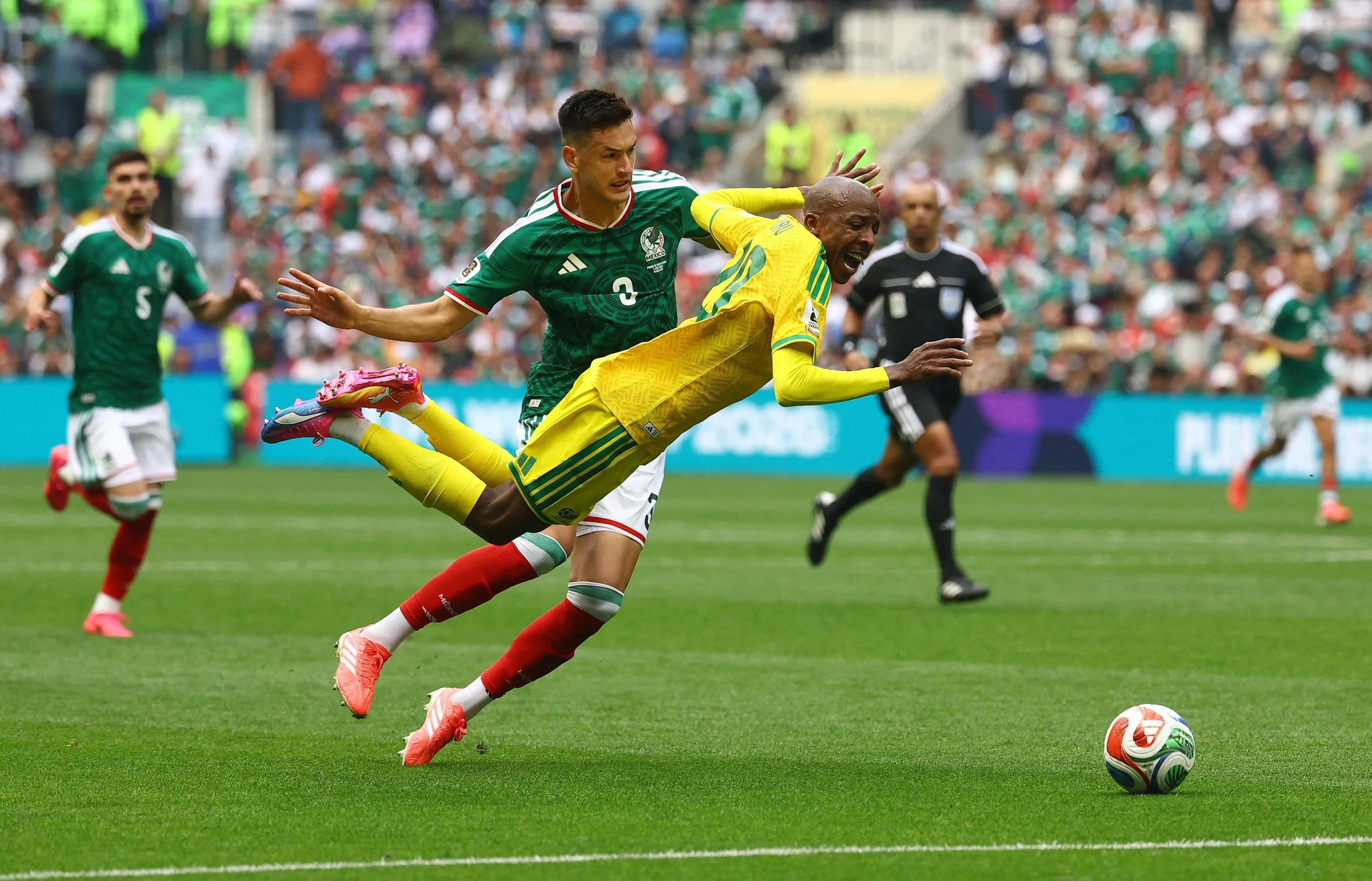 Mexico’s César Montes commits his red card offence against South Africa’s Khuliso Mudau.