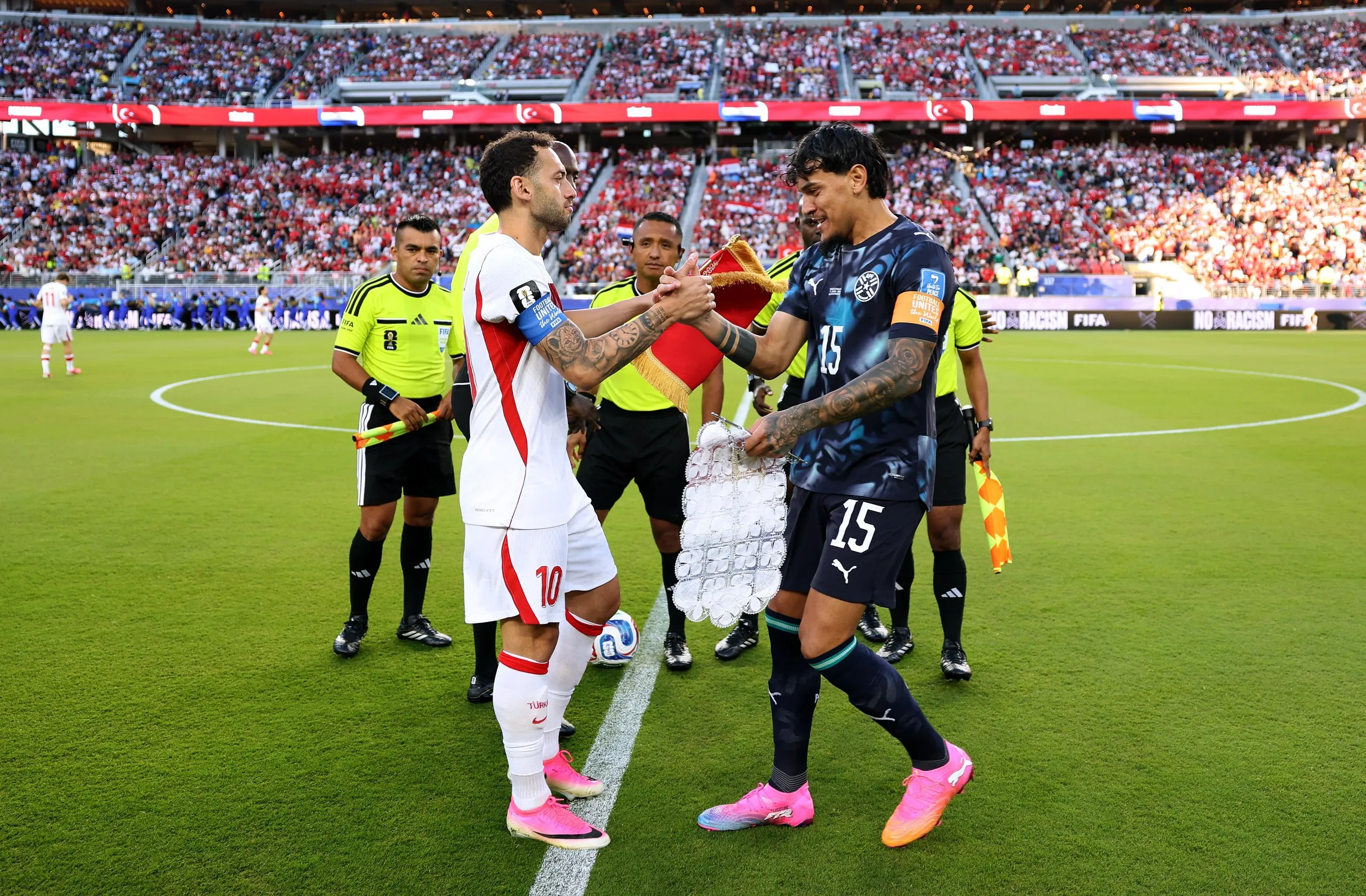 Hakan Calhanoglu (10) of Turkey shakes hands with Gustavo Gomez (15) of Paraguay