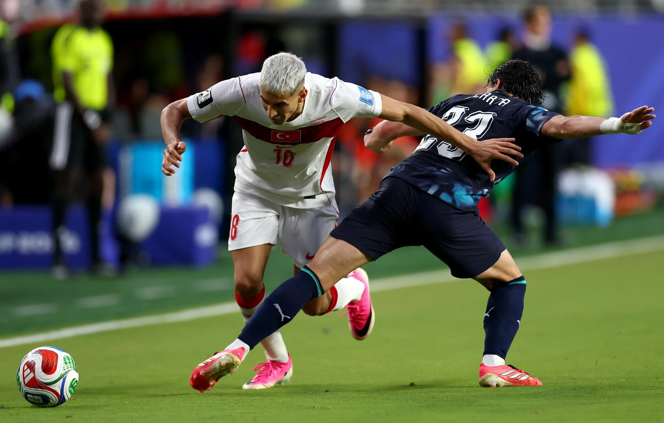 Mert Muldur (18) of Turkey is challenged by Matias Galarza (23).