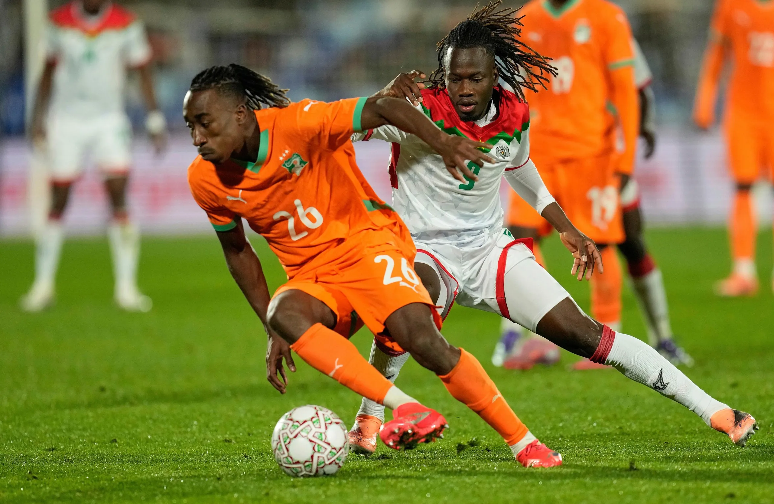 Côte d’Ivoire’s Yan Diomande attempts to evade Burkina Faso’s Issa Kaboré in Marrakech