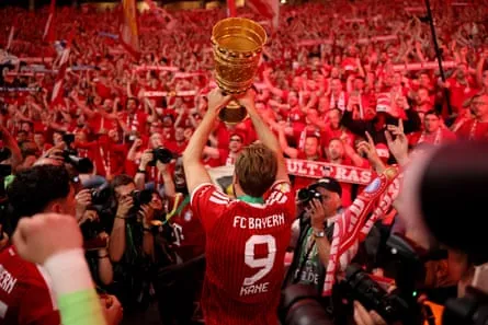 Kane Lifts DFB Cup Harry Kane hoists the DFB Cup aloft in May after Bayern’s win over Stuttgart