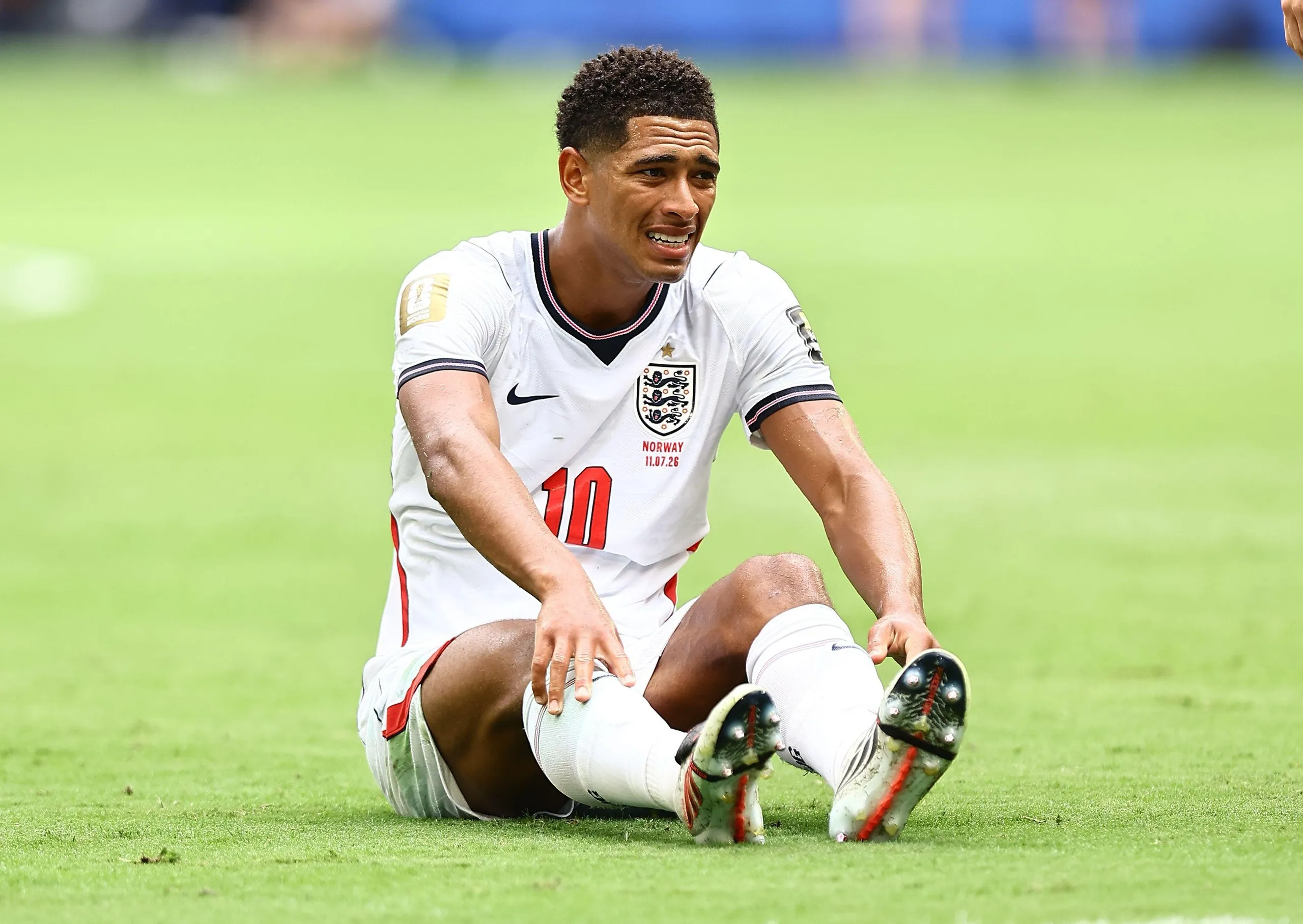 Jude Bellingham sits on the pitch exhausted