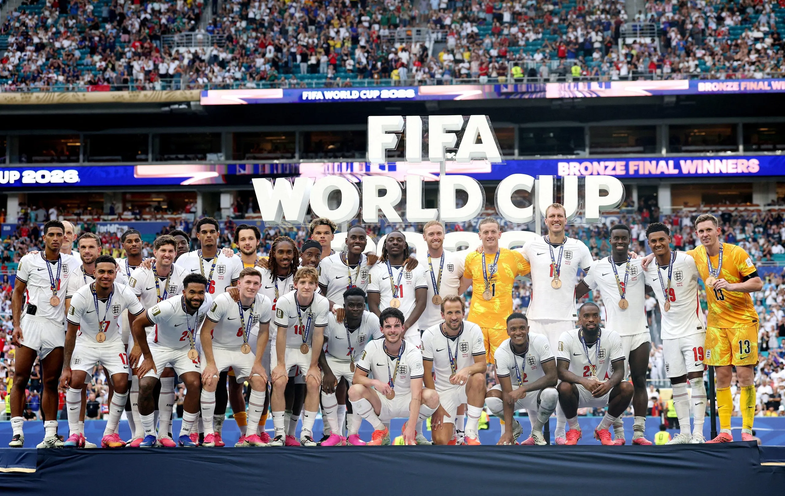 England players pose on the podium during the medal ceremony